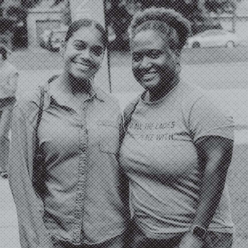 Two women smiling together outside after a Sunday service